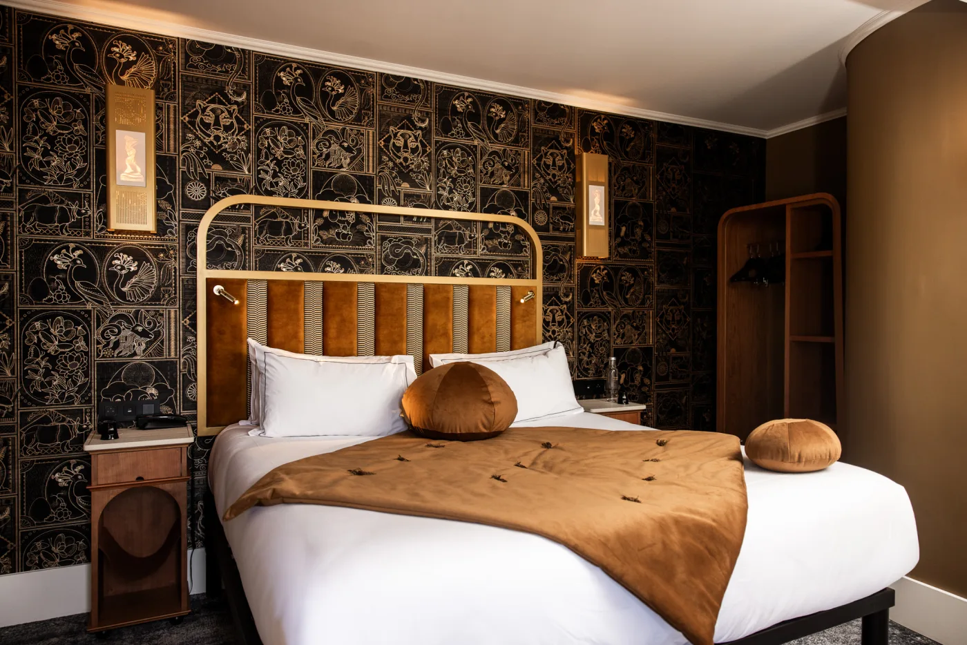 Deluxe room front view - king bed, amber headboard, Art Deco wallpaper